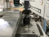 Close-up of a glazing bead end profile scribing machine cutting a timber wooden bead on a metal workbed