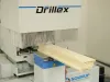 Soukup Drillex work centre drilling a timber wooden board with dust extraction bristles visible