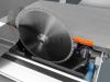 Large circular saw blade mounted on a Robland Z500 M sliding table saw with an orange blade guard